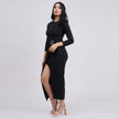 Woman wearing a black dress with a slit on a white background